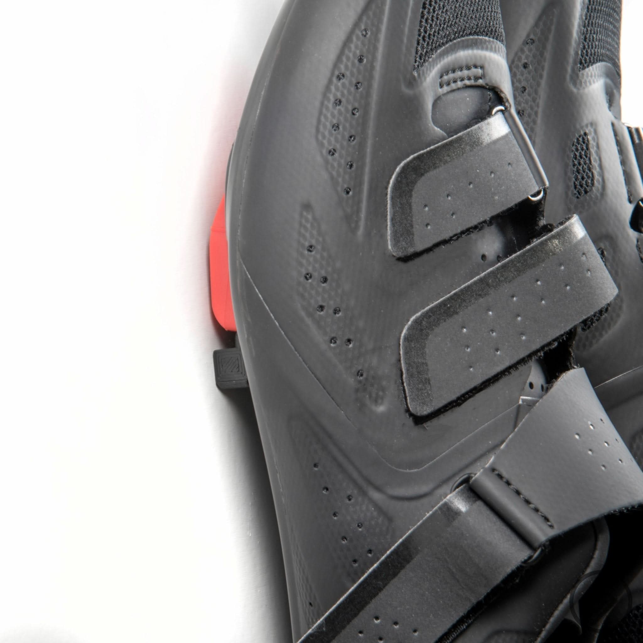 Peloton Delta spin shoes shown hung on the Spartan Mounts wall hook for organized, off-the-floor storage