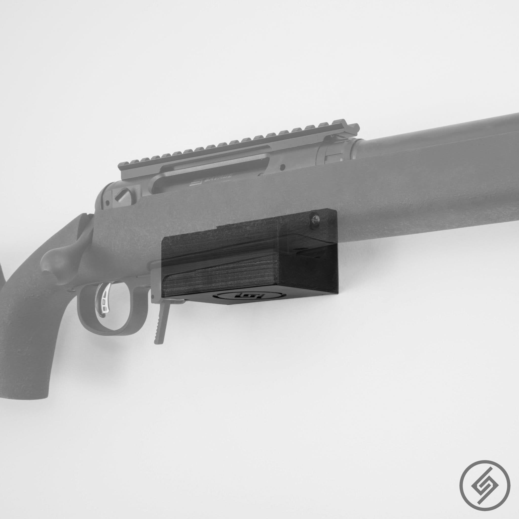 Savage Lapua Magnum rifle shown mounted on the Spartan Mounts wall hook for secure gun room storage