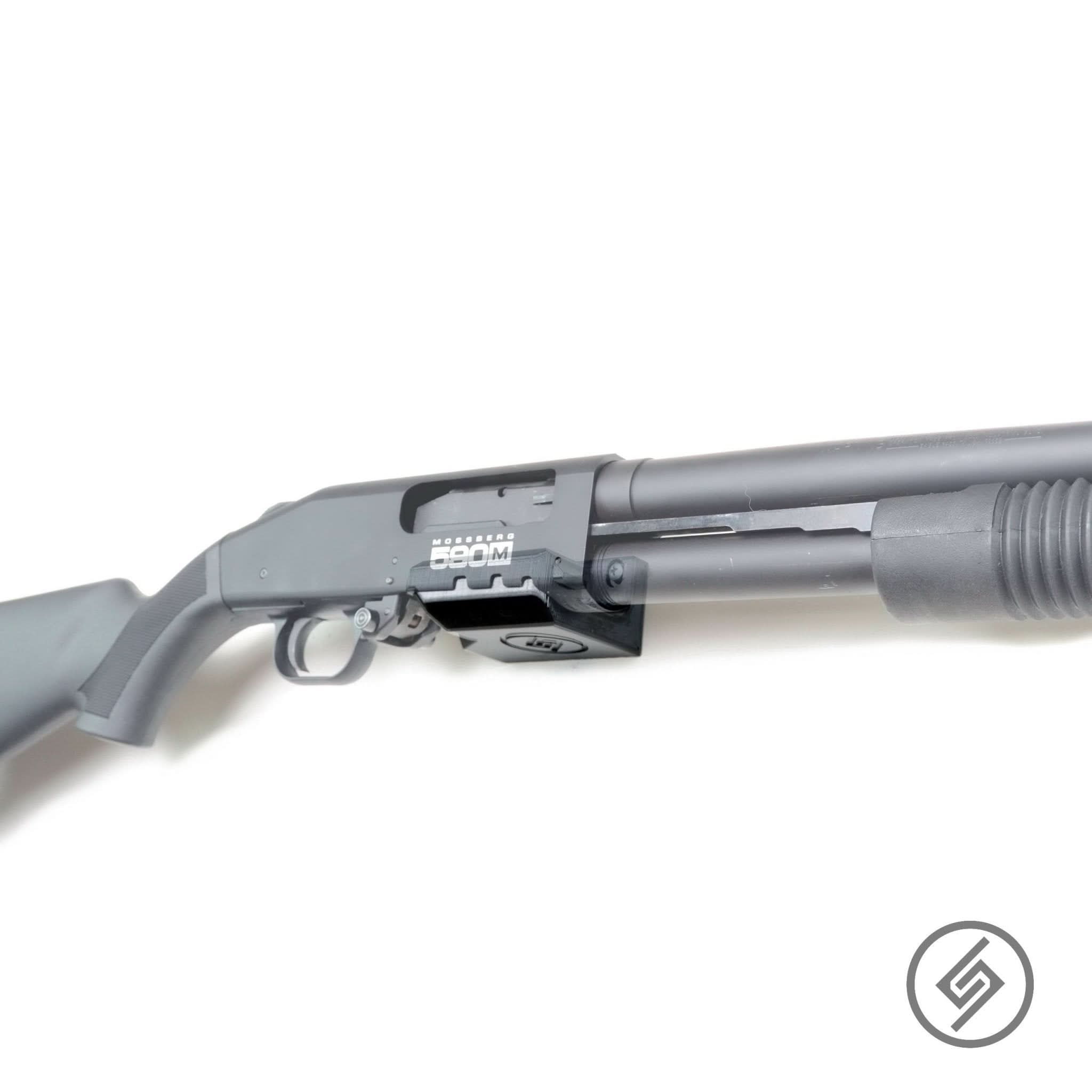 Mossberg 590M shotgun shown mounted on the Spartan Mounts wall hook for secure, quick-access storage