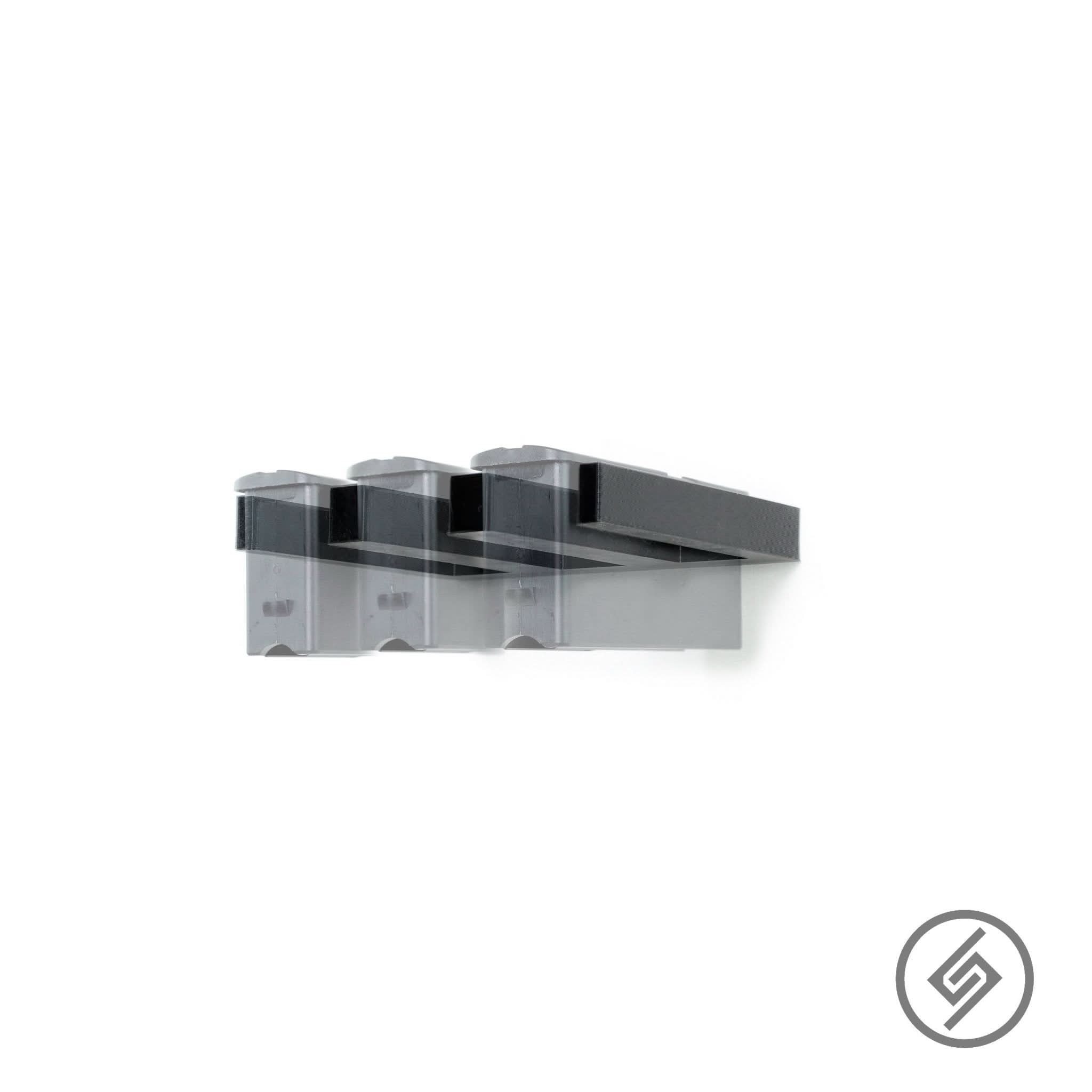 Mossberg Patriot long-action magazines shown loaded in the Spartan Mounts wall rack for organized, off-the-floor storage