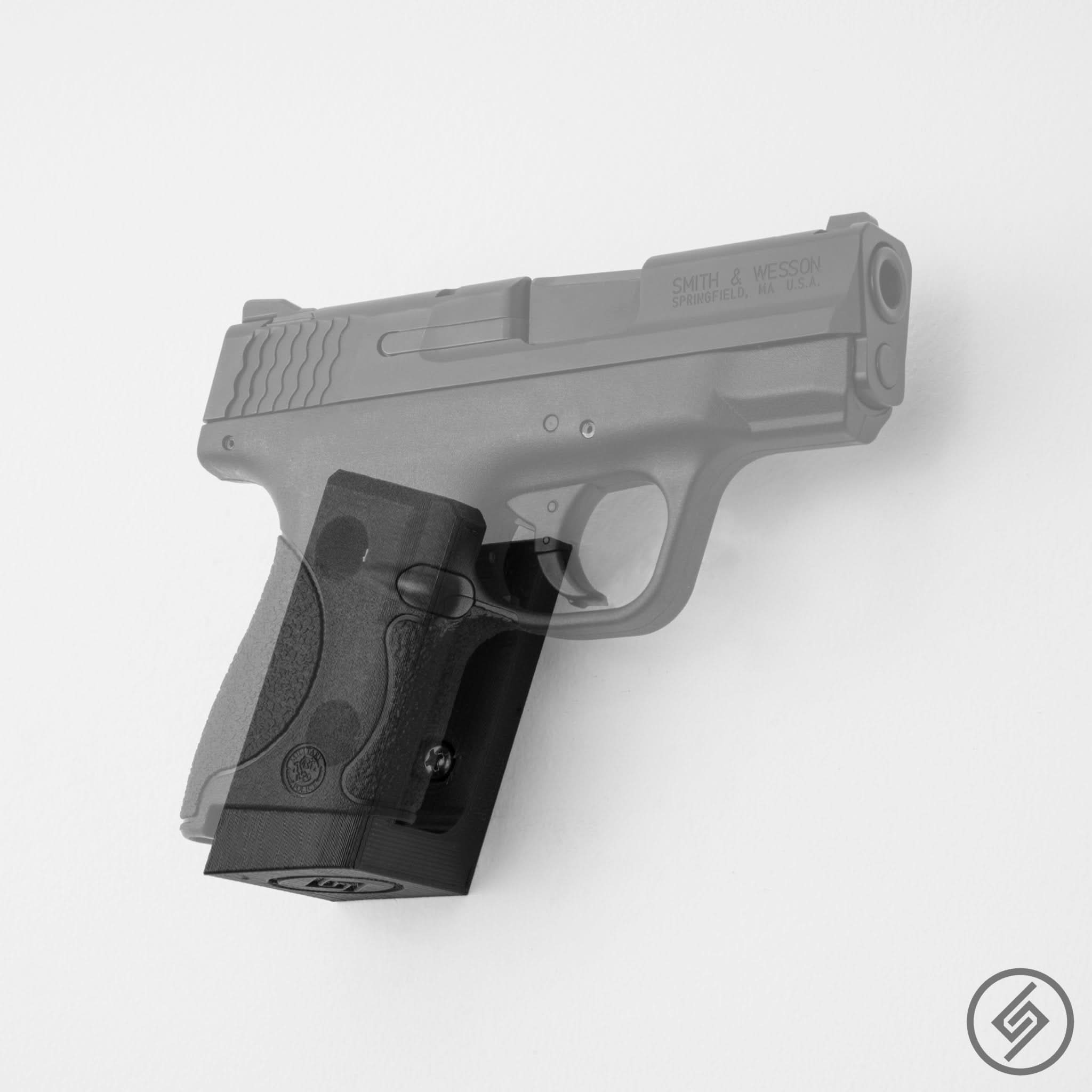 M&P Shield pistol shown mounted on the Spartan Mounts wall hook for secure, quick-access storage