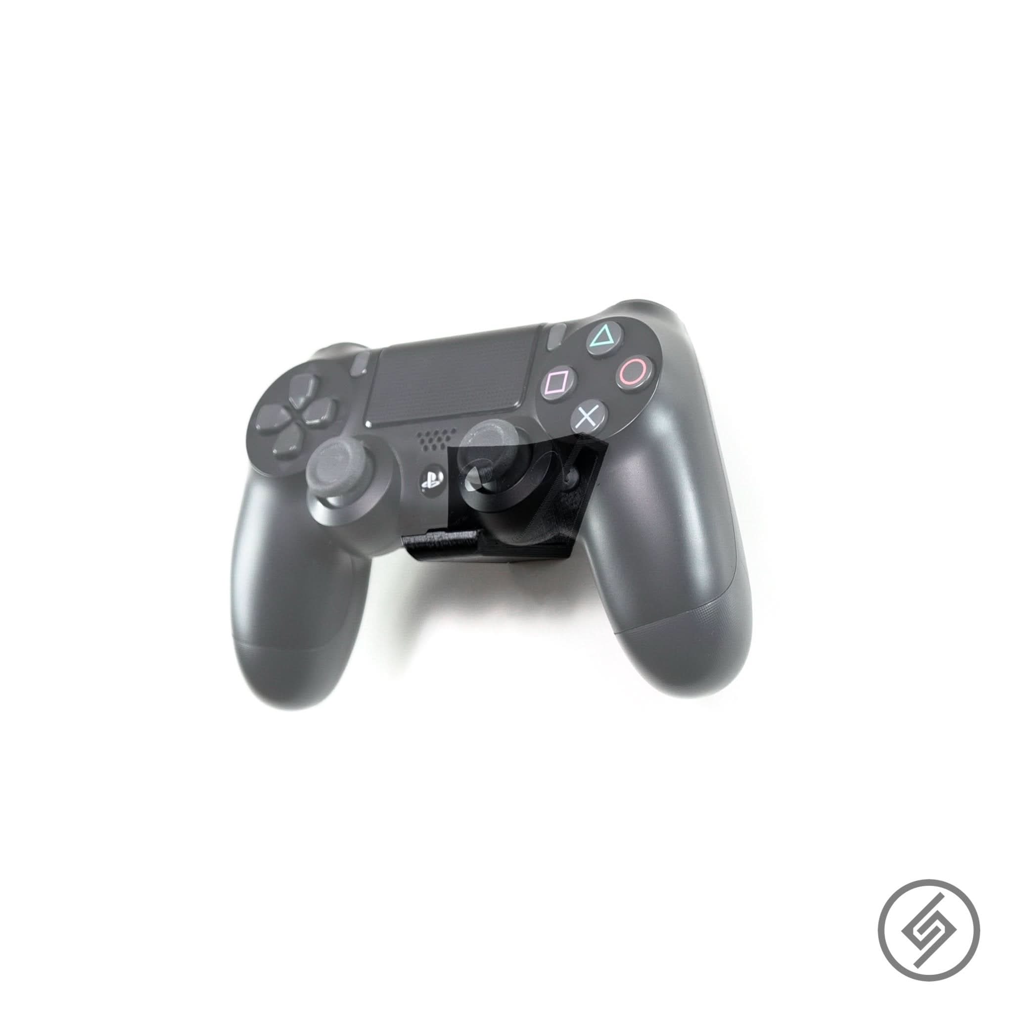 PlayStation controller shown mounted on the Spartan Mounts wall hook for organized, off-the-floor storage