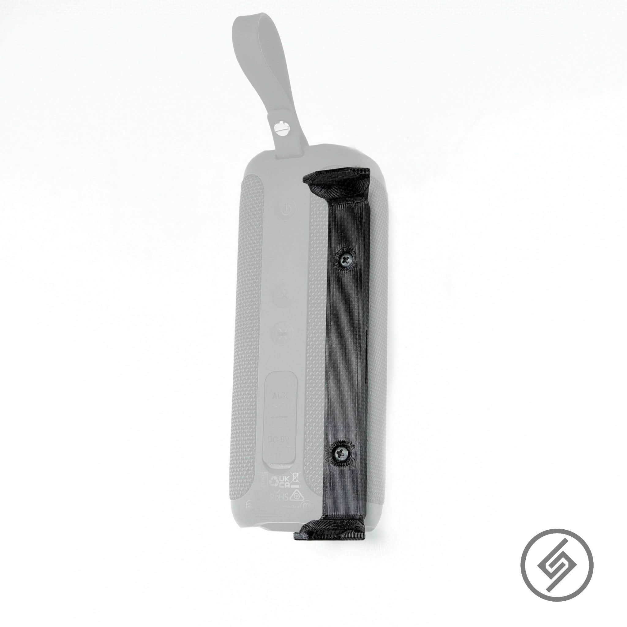 Tribit StormBox speaker shown mounted on the Spartan Mounts wall mount for a clean, space-saving setup