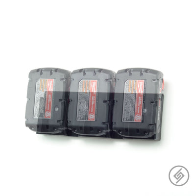 Three Milwaukee M18 batteries shown loaded in the Spartan Mounts wall rack for organized shop storage