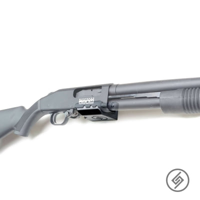 Mossberg 590M shotgun shown mounted on the Spartan Mounts wall hook for secure, quick-access storage