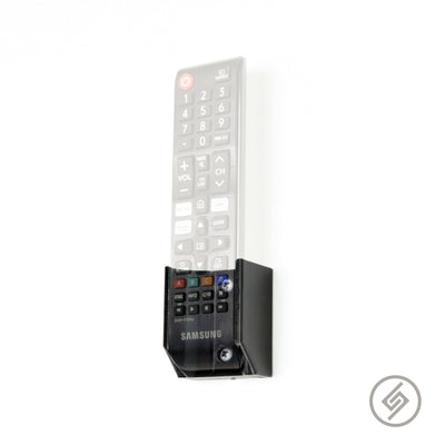Samsung TV remote shown mounted on the Spartan Mounts wall mount for a clean, easy-access setup