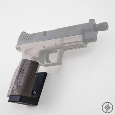 Springfield XDM pistol shown mounted on the Spartan Mounts wall hook for secure, quick-access storage